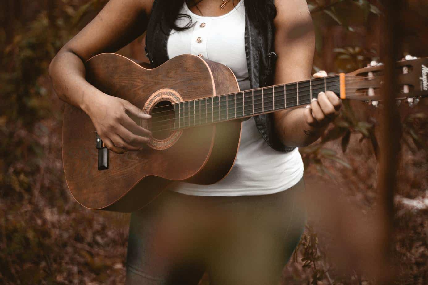 acoustic guitar played by woman