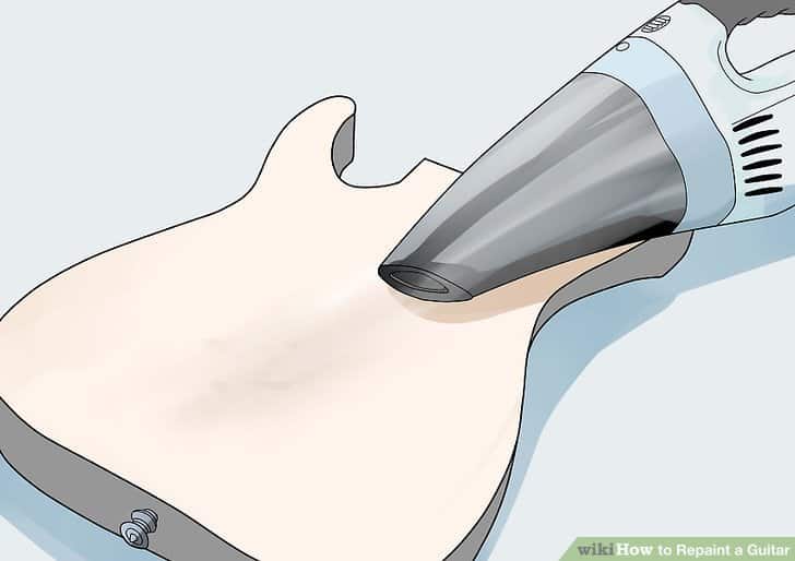 Vacuuming up mess on a guitar