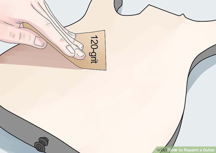 smoothing out the wood on a guitar